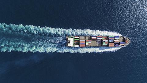 An image showing an aerial view of a container ship