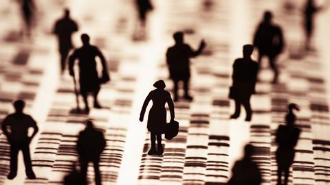 The image shows silhouette humans against a digital data backdrop