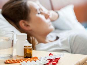 Person sleeping with pills beside them
