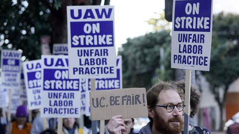 People on a protest. Their placards read UAW on strike.
