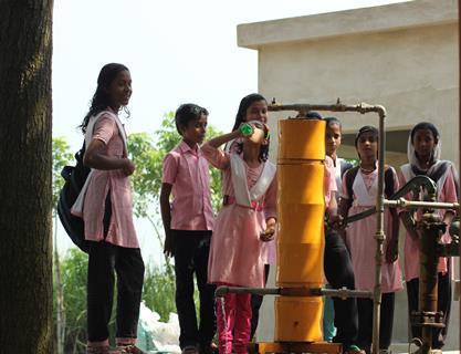 AMRIT drinking water purification unit using nanomaterials connected to a hand pump  installation in a school
