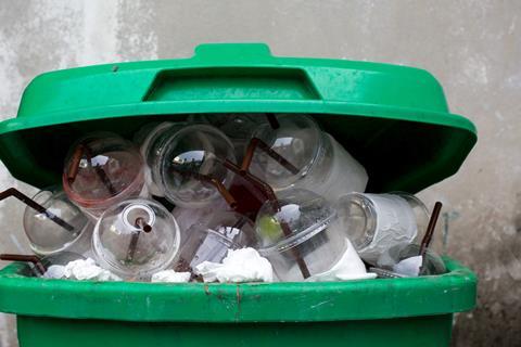 An image showing lots of single use plastic cups in a trash can