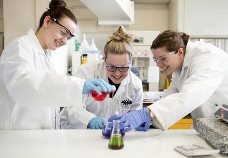 Three female scientists in an AWE lab