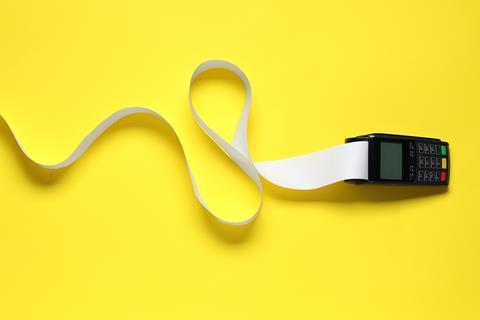 A handheld receipt printer with lots of receipt paper