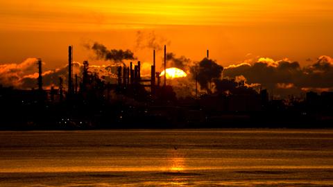 Sun rising over refinery
