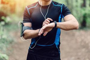 runner with smartphone and watch