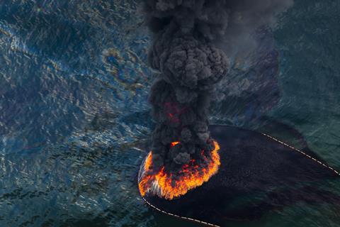 A plume of smoke rises from the burn of collected crude oil spilled from the burst well head of the Deepwater Horizon in the Gulf of Mexico in May 2010.