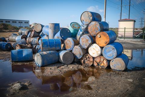 An image showing oil drums polluting the environment around them 