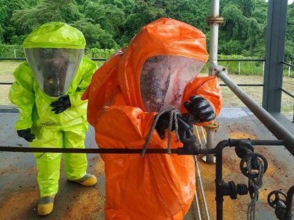 Two people in hazmat suits