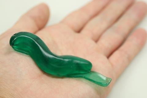 A green strip of 'slug glue' on a hand