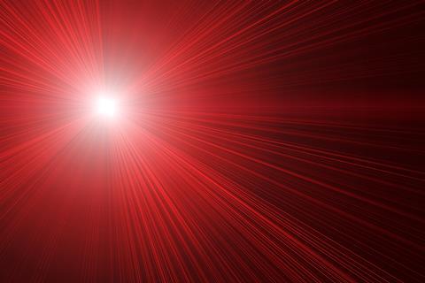 An image showing red laser beams on black