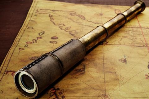 Close-up of a spyglass on the old map