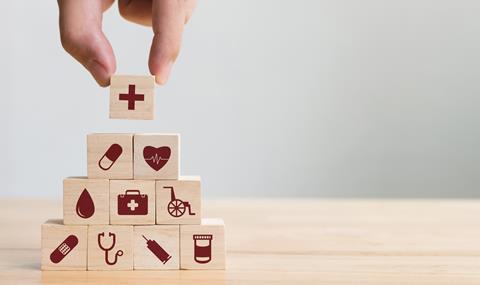 Stacking wooden blocks printed with healthcare-related icons
