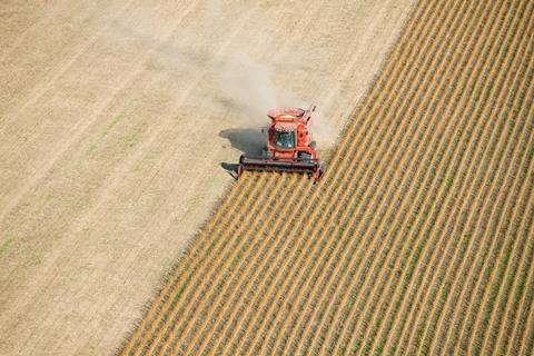 An image showing a harvesting machine in a field
