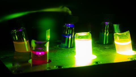 Image of photochemical vials glowing in the dark