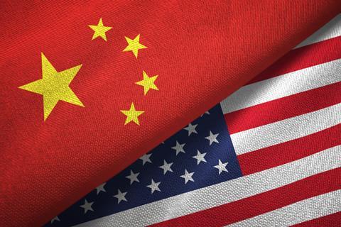 An image showing a Chinese flag on top of a US flag