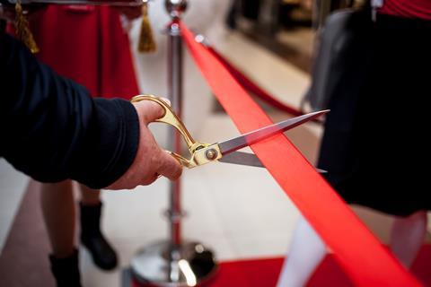 An image showing red tape being cut 