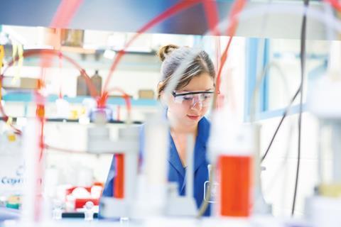 Image shows a female scientist in the lab