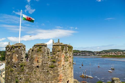 The Red Dragon flies above a Welsh castle