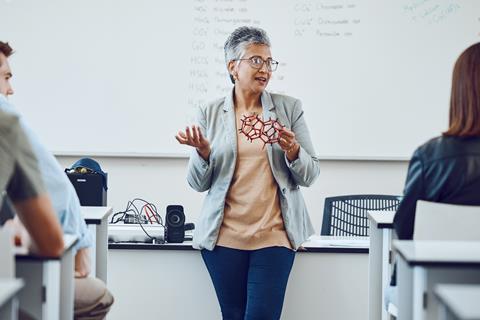 A female professor giving a chemistry lecture