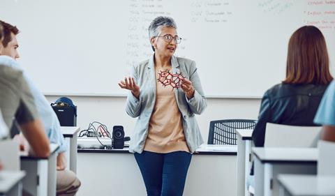 A female professor giving a chemistry lecture