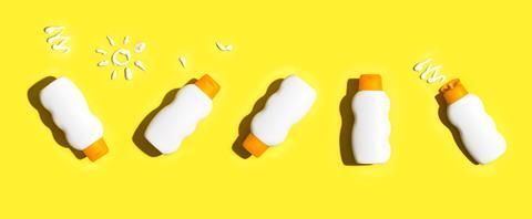 Sunscreen bottles on a yellow background