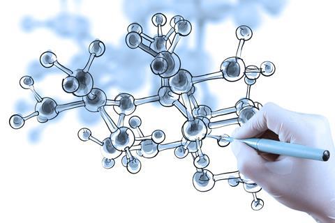 An image of a hand drawing a molecular structure