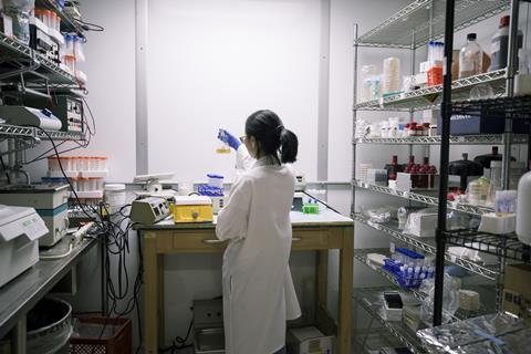 A photo of a young woman working in a laboratory