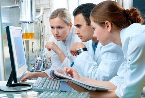 scientists staring at a computer screen