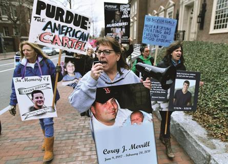 Photo of Cheryl Juaire holding speakerphone, leading protesters near the Arthur M. Sackler Museum at Harvard University, in the US
