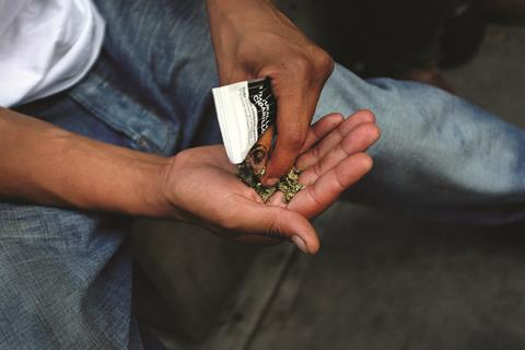 Man prepares to smoke synthetic marijuana drug