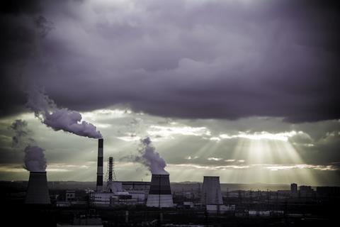 Moody dark clouds over thermal power plant