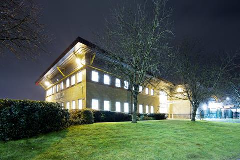 A night image of the Unit DX building