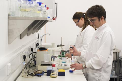 An image showing chemists working on the bench inside one of the Unit DX laboratories