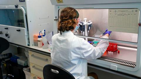 An image showing a scientist undergoing Covid research