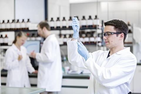 A photograph of a chemist working in a lab