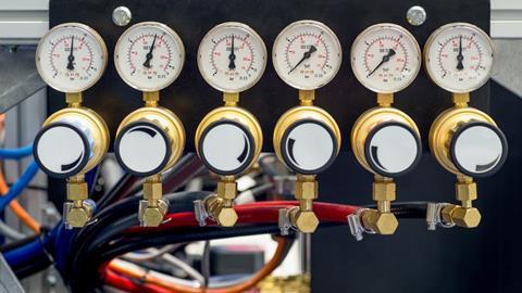 An image showing a manometer, pressure gauge and valves