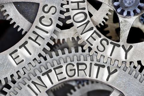 Macro shot of gears showing ethics, honesty and integrity