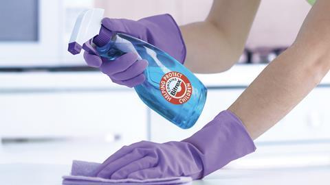 A Bitrex cleaning product in the rubber-gloved hands of someone cleaning