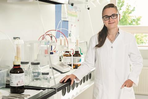 Image shows a female scientist in the lab