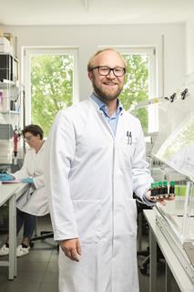 Image shows a male scientist in the lab
