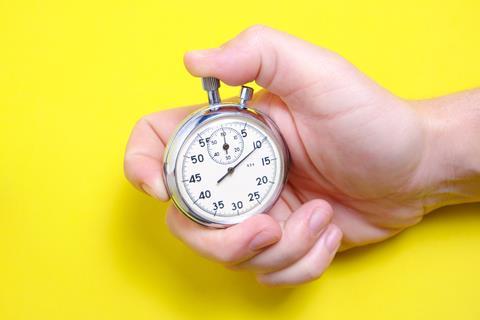 Hand holding an analogue stopwatch