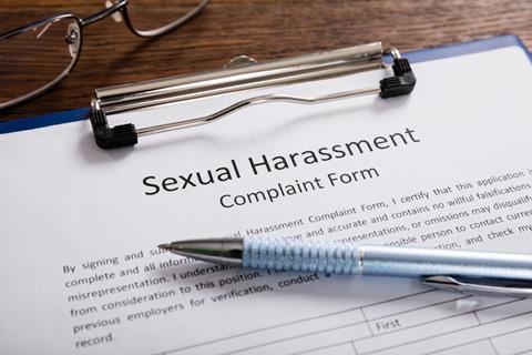Close-up Of Sexual Harassment Complaint Form With Pen At Desk