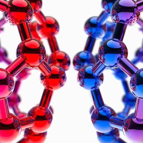 A close-up of a ball-and-stick model of two buckminsterfullerene molecules