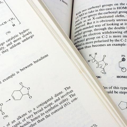 A close-up photo showing overlapping pages in an organic chemistry textbook, apparently in the section that discusses the Diels-Alder reaction.