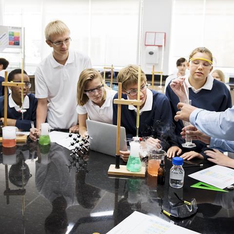 Enthralled students watch a science experiment