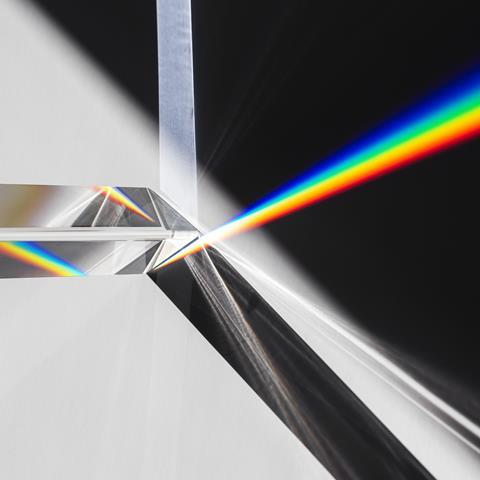 An image showing a prism breaking up a beam of white light into its rainbow-coloured constituents