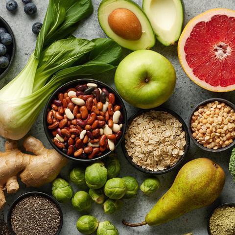 Various fresh healthy products on grey table, top view