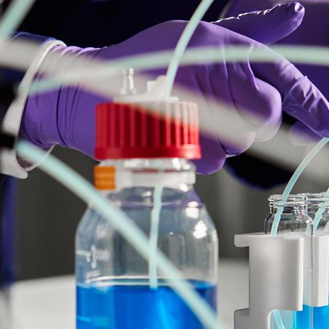Laboratory photo showing a scientist working with Syris Atlas HD Syringe Pump lab bench equipment