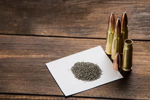 A pile of gun powder surrounded by bullets